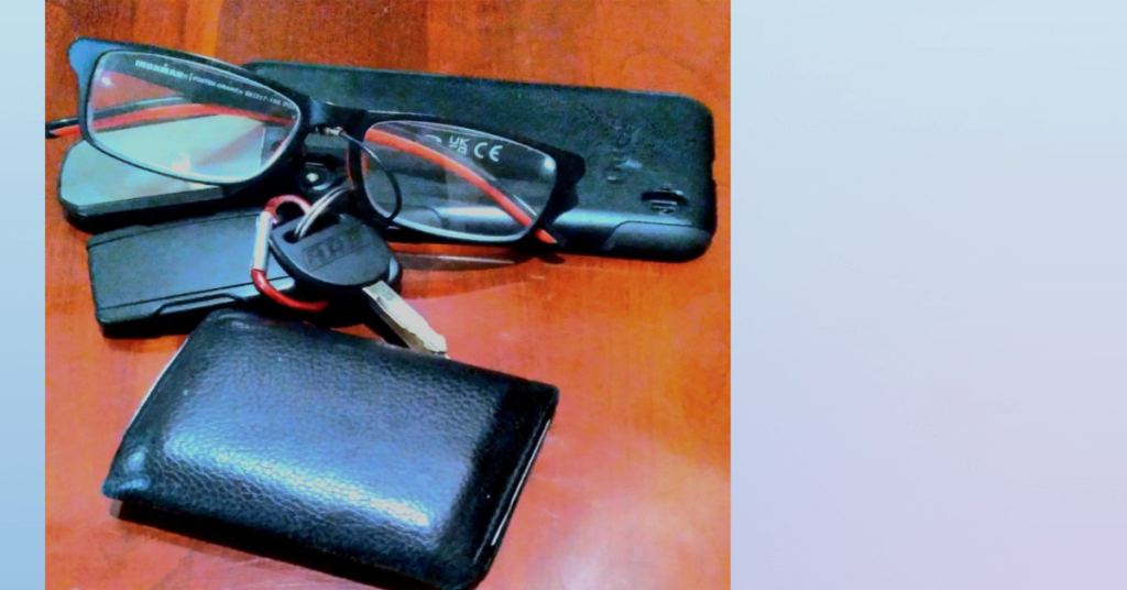 Wallet, keys and glasses on hotel furniture