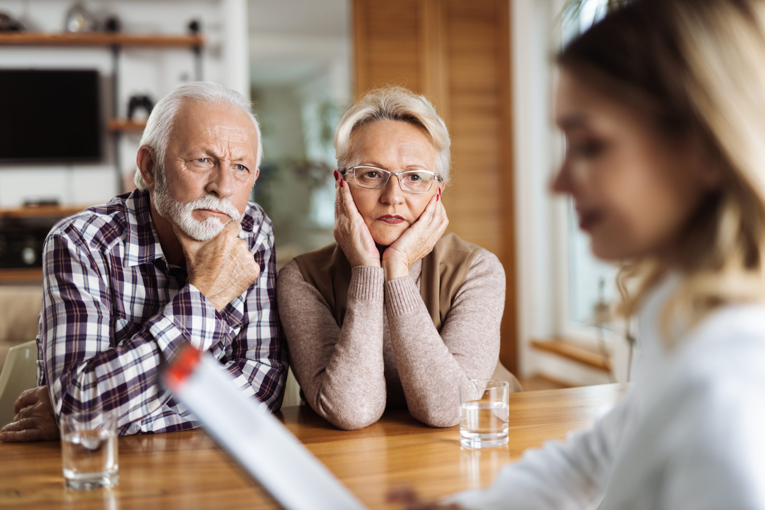 Couple listening intently to doctor